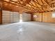 Spacious two-car garage interior with visible rafters and unfinished walls, providing ample storage at 10186 W Nc-97 Hwy, Middlesex, NC 27557