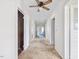 Long hallway with multiple rooms, doorways, a ceiling fan, and neutral carpet at 10186 W Nc-97 Hwy, Middlesex, NC 27557