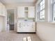 Vintage kitchen includes a sink and wood cabinets, with natural light streaming in from a side window at 10186 W Nc-97 Hwy, Middlesex, NC 27557