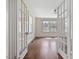 Bright living room with hardwood floors, complemented by natural light streaming through large windows and charming glass doors at 10186 W Nc-97 Hwy, Middlesex, NC 27557