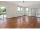 Empty living room featuring hardwood floors, multiple windows for natural light, and classic architectural details at 10186 W Nc-97 Hwy, Middlesex, NC 27557
