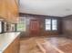 A rustic living area showcases wood-paneled walls, complemented by natural light from surrounding windows at 10186 W Nc-97 Hwy, Middlesex, NC 27557