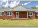 Close up view of a brick porch with brick columns and a decorative tile floor at front entrance at 10186 W Nc-97 Hwy, Middlesex, NC 27557