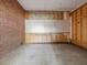 Unfinished room with brick and wood walls and a concrete floor at 10186 W Nc-97 Hwy, Middlesex, NC 27557
