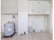 Well-lit utility area features white walls, a water heater, and convenient storage shelves for home maintenance needs at 10186 W Nc-97 Hwy, Middlesex, NC 27557