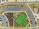 Aerial view of community tennis courts and parking area at 1024 Channel Drop, Zebulon, NC 27597