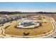 Aerial view of the community pool and clubhouse surrounded by new single-Gathering homes and undeveloped land at 1024 Channel Drop, Zebulon, NC 27597