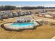 Community pool and clubhouse located among modern homes in a development with playground, near construction at 1024 Channel Drop, Zebulon, NC 27597