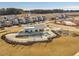 Community pool and clubhouse surrounded by contemporary homes in a neighborhood under development with nearby playground at 1024 Channel Drop, Zebulon, NC 27597