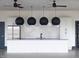 Island kitchen features granite countertops, subway tile backsplash, stainless fridge and decorative lighting at 1024 Channel Drop, Zebulon, NC 27597