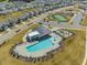 Aerial shot captures the community pool, clubhouse, playground, tennis courts, and parking area at 1033 Channel Drop Lp, Zebulon, NC 27597