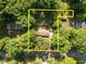Aerial view of a single-story home, surrounded by mature trees and a well-maintained yard at 108 Jefferson Dr, Durham, NC 27712