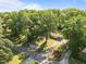Home surrounded by mature trees, featuring a well-maintained lawn and a paved driveway at 108 Jefferson Dr, Durham, NC 27712