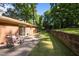 Backyard patio showcasing outdoor seating and a well-maintained retaining wall with lush greenery at 108 Jefferson Dr, Durham, NC 27712