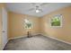 Carpeted bedroom with two windows and a ceiling fan at 108 Jefferson Dr, Durham, NC 27712