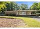 Charming single-story home with a brick facade, covered carport and mature landscaping at 108 Jefferson Dr, Durham, NC 27712