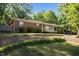 Charming single-story home with a brick facade, mature landscaping, and a manicured lawn at 108 Jefferson Dr, Durham, NC 27712