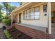 Charming front porch with brick accents, a curved window and mature landscaping at 108 Jefferson Dr, Durham, NC 27712