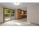 Eat-in kitchen with wood cabinets and a sliding glass door to the back yard at 108 Jefferson Dr, Durham, NC 27712