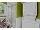 Bathroom laundry area featuring stackable washer and dryer with white wooden wainscoting at 108 Jefferson Dr, Durham, NC 27712