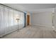 Spacious living room with neutral carpeting, soft natural light, and a traditional standing lamp at 108 Jefferson Dr, Durham, NC 27712