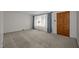 Inviting living room features neutral carpeting, natural light, and a warm traditional lamp at 108 Jefferson Dr, Durham, NC 27712