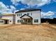 The backyard shows a new build with a covered porch and unfinished landscape at 109 Moonflower Ln # Homesite 260, Wilson's Mills, NC 27520