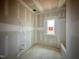 Unfinished bathroom showcasing a window with a bathtub and fixtures and potential for customization at 109 Moonflower Ln # Homesite 260, Wilson's Mills, NC 27520