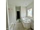 Bright bathroom featuring a window and tub partially covered, ready for final touches at 109 Moonflower Ln # Homesite 260, Wilson's Mills, NC 27520