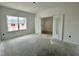 Unfinished room featuring large windows and double doors to an adjacent room at 109 Moonflower Ln # Homesite 260, Wilson's Mills, NC 27520