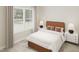 Bright bedroom featuring a large window, comfortable bed and stylish decor at 109 Moonflower Ln # Homesite 260, Wilson's Mills, NC 27520