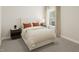 Cozy bedroom featuring a comfortable bed, bedside table, and ample lighting at 109 Moonflower Ln # Homesite 260, Wilson's Mills, NC 27520
