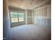 Unfinished bedroom with a large window and drywall ready for paint at 109 Moonflower Ln # Homesite 260, Wilson's Mills, NC 27520