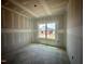 Unfinished bedroom showcases a bright window, offering natural light and potential for customization at 109 Moonflower Ln # Homesite 260, Wilson's Mills, NC 27520