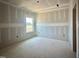 Unfinished bedroom displays a window offering natural light and potential for custom design at 109 Moonflower Ln # Homesite 260, Wilson's Mills, NC 27520