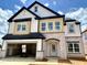 New two-story home with stone accents, a two-car garage, and a covered entryway at 109 Moonflower Ln # Homesite 260, Wilson's Mills, NC 27520