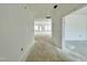 Unfinished interior of home showing entry hallway and living area with natural light at 109 Moonflower Ln # Homesite 260, Wilson's Mills, NC 27520
