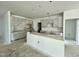 Unfinished kitchen featuring a large island and cabinets covered in plastic at 109 Moonflower Ln # Homesite 260, Wilson's Mills, NC 27520