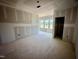 Unfinished living room with drywall, featuring large windows allowing ample natural light at 109 Moonflower Ln # Homesite 260, Wilson's Mills, NC 27520