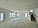 Unfinished living room with multiple windows and a staircase visible at 109 Moonflower Ln # Homesite 260, Wilson's Mills, NC 27520