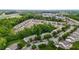 View of a residential area with townhomes, tree-lined streets, and parking offering a blend of nature and convenience at 1096 Kelso Ln # 18, Burlington, NC 27215