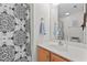 Bright bathroom with a decorative shower curtain, light wood vanity, and white countertop at 1096 Kelso Ln # 18, Burlington, NC 27215