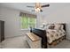 Comfortable bedroom with a large window, ceiling fan, and stylish bedding creates a relaxing atmosphere at 1096 Kelso Ln # 18, Burlington, NC 27215