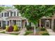 Townhome exterior featuring brick and gray siding, black shutters, and manicured landscaping at 1096 Kelso Ln # 18, Burlington, NC 27215