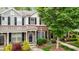 Townhome exterior with brick and gray siding, black shutters, and landscaped yard at 1096 Kelso Ln # 18, Burlington, NC 27215