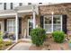 Inviting front porch with brick accents, a 'Welcome' sign, and comfortable seating at 1096 Kelso Ln # 18, Burlington, NC 27215