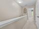 Upstairs hallway with neutral paint and carpet, with a view into a bedroom at 1096 Kelso Ln # 18, Burlington, NC 27215