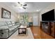 Inviting living room with hardwood floors, a ceiling fan, and a cozy fireplace at 1096 Kelso Ln # 18, Burlington, NC 27215