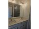 Well-lit bathroom featuring a double sink vanity with framed mirrors and a glass shower at 12 Lavender Ln, Clayton, NC 27520