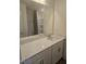 Bright bathroom featuring a large mirror, vanity with a white countertop and shower and tub combo at 12 Lavender Ln, Clayton, NC 27520